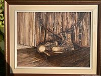 Full view of framed painting showing boots scene