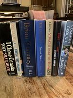 All seven signed autobiographies standing side by side showing spines