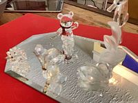 Group of five Swarovski crystal figurines on mirrored base