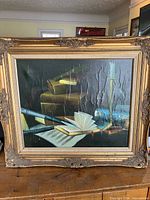 Full view of framed oil painting on canvas depicting books, open book, candlestick, showing frame and canvas condition