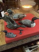 Group shot of all five carvings on red surface