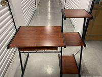 Full view of desk showing main top, keyboard tray, side shelves, metal frame