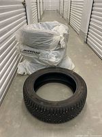 Four Continental IceContact tires, three bagged, one unbagged