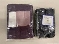 Plum Living Quarters bedskirt package alongside black Royal Velvet king flat sheet package
