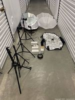 Full layout of lighting kit with stands, umbrellas, softbox, bulbs, adapters