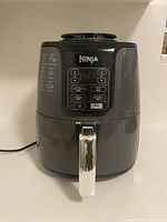 Front view of Ninja air fryer showing control panel and handle