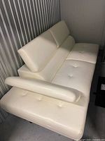Full view of white leather sectional sofa