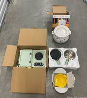 All items together: breakfast station in box, slow cooker, pans, yellow pot