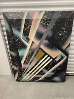 Full view of the abstract painting leaning against wall