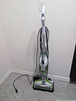 Full front view of Bissell CrossWave vacuum with power cord and base