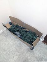 Cardboard box containing disassembled artificial Christmas tree