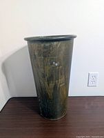 Front view of brass cylindrical stand