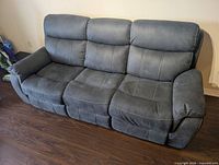 Front view of charcoal gray 3-seat manual reclining sofa