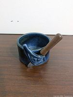Front view of bowl with spreader resting in holder