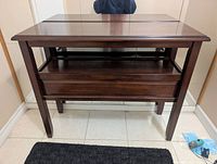 Front view of console table showing legs, shelf and overall finish
