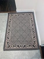 Full view of rug on floor showing entire pattern and scale