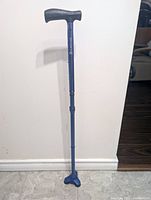 Full view of blue HurryCane showing handle to tri-foot base