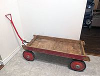 Overall right side view of Jetliner wooden wagon with red wheels and handle
