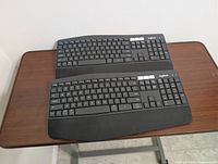 Top view of both Logitech K850 keyboards showing full key layout and palm rests