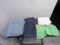 All five textiles laid flat on table showing size and color variety