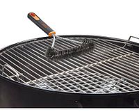 Grill brush in use on grill grate