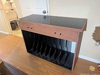 Front view showing two drawers and nine vertical dividers