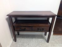 Front view of console table showing top, shelf and drawers