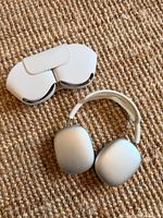 Headphones and Smart Case side by side on textured surface