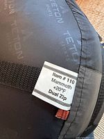 Close-up of sleeping bag tag showing Item #110 Mammoth +20°F Dual Zip