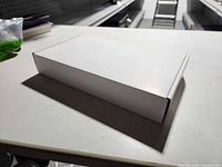 Closed white box on table