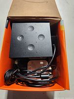 Cube, power adapter and cable inside box