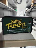 Front view showing Battery Tender Plus branding and specs