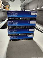 Stack of four unopened Microflex Cobalt glove boxes