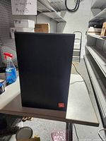 Front view of powered subwoofer showing grille and cabinet