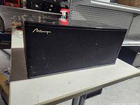 Front view with grille on showing Mirage logo