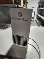 Front view showing NOVAERUS logo, intake grille and power cord