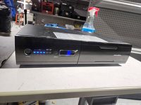 Front view showing power button, LED display and Panamax branding