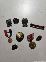 All eight U.S. Army badges, medals and ribbon bar displayed