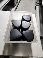 Five black Jensen satellite speakers in plastic bin