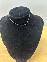 Bracelet displayed on jewelry bust showing chain and clasp