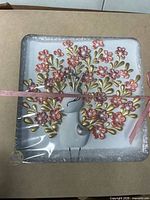 Front view of boxed 3D artwork showing floral bird design