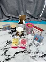 Group shot showing all items: candle, wax warmer, wax sprinkles, wax melt packs, hand warmers