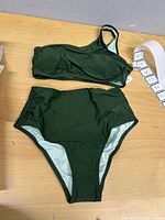 Full view of one-shoulder bikini top and high-waisted bottom laid flat