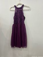 Front view of purple lace and tulle cocktail dress on hanger