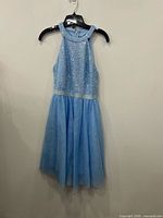 Full view of light blue sequined halter dress on hanger
