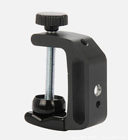 Close-up of single Q-type clip showing screw press, mounting hole and ball-joint base