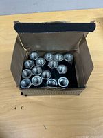 Open box showing all 15 coupling nuts