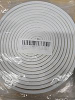 Close-up of one white foam seal roll in factory bag