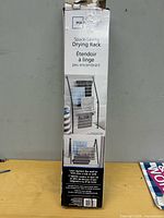 Front of retail box showing Mainstays space-saving drying rack