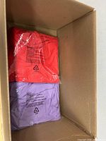 Two sealed cloth pieces inside cardboard box